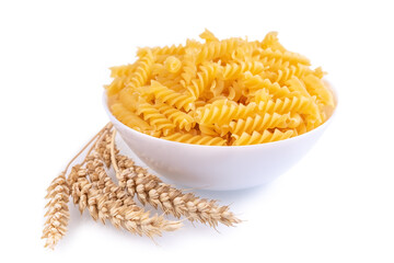 Pasta and wheat spikelets isolated on white background, banner, header, template with copy space. Raw pasta fusilli, ingredient for cook, traditonal italian cuisine. Side view