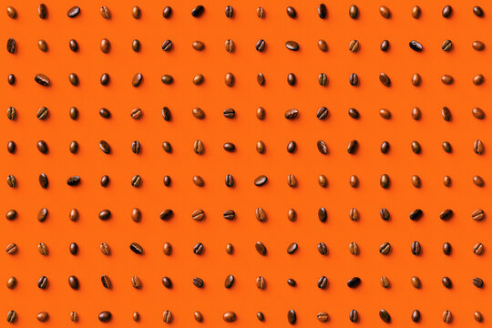 Roasted coffee beans on an orange background
