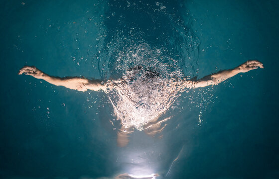 Dreamy portrait of submerged woman inside pool