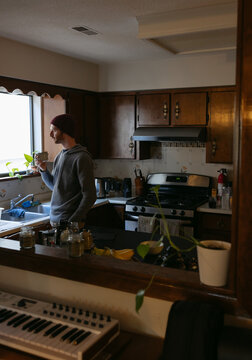 Man drinking coffee in retro kitchen.