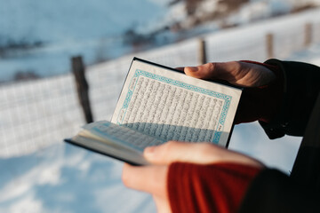 man scrolling through Quran