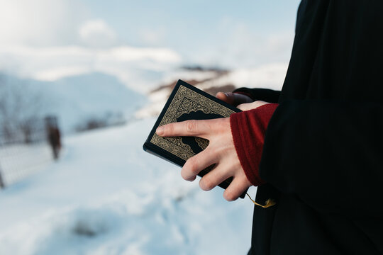 man scrolling through Quran