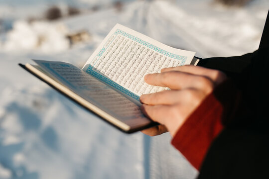 man scrolling through Quran