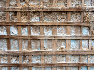 Aged wooden grid on the wall. Old wooden texture.