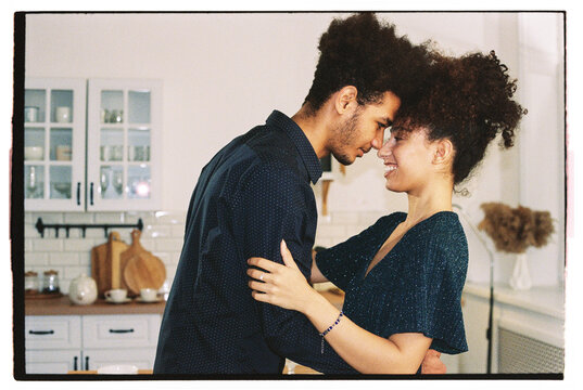Man embraces woman in a dance in the kitchen.