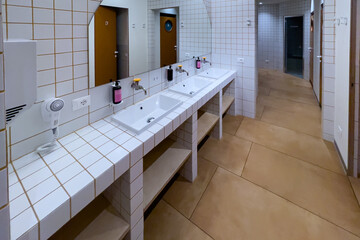 A clean modern shared bathroom inside a hostel
