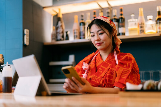 Owner of restaurant working on cellphone in the night club