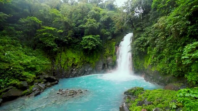 Catarata Rio Celeste, waterfall of blue river Rio Celeste, Parque Nacional Volcan Tenorio, Costa Rica, Central America, panning shot, slow motion