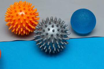 three small pilates balls on a gray elastic band