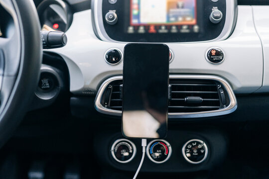 Modern smartphone on holder in car