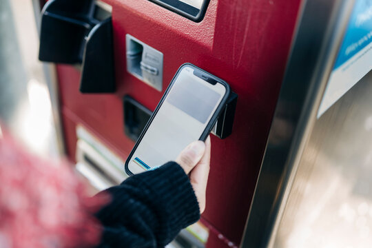 Crop woman paying for tickets with smartphone