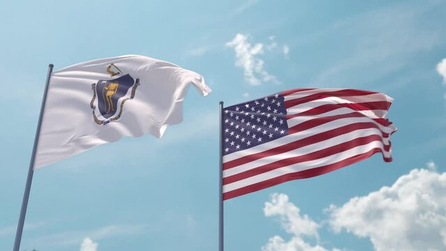 Massachusetts and the USA on a flagpole realistic wave on strong wind in blue sky. Commonwealth of Massachusetts and The United States of America