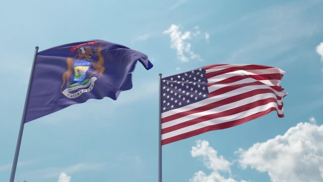 Michigan and the USA on a flagpole realistic wave on strong wind in blue sky. State of Michigan and The United States of America
