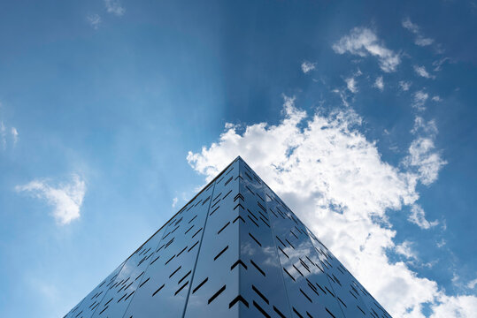  Modern building corner with clouds reflecting on its facade