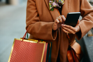 Close up of woman using mobile phone while shopping.