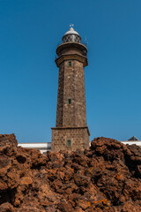 Beautiful Orchilla lighthouse with volcanic stones on the southwest coast of El Hierro. Canary Islands