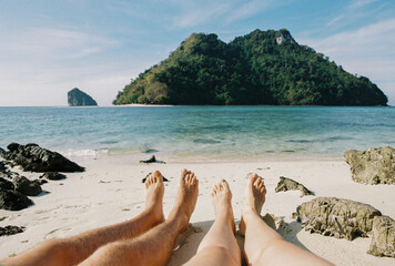 A couple resting on the beach