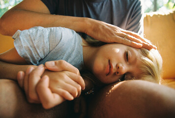 Daughter resting on father's laps