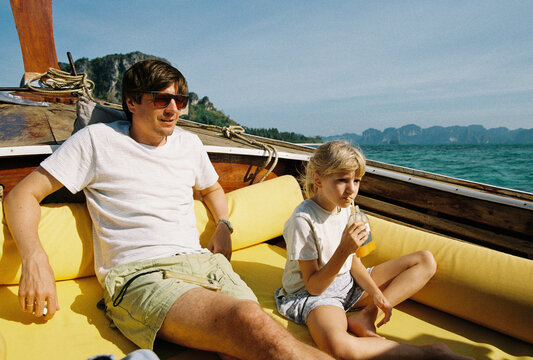 Father with daughter n a boat in Thailand