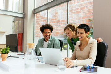 Group of diverse colleagues discussing project in office