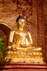 Fototapeta premium The Phra Buddha Sihing statue in the Viharn Lai Kham at Wat Phra Singh , Chiang Mai , Thailand