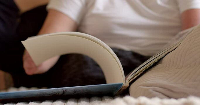 Flipping printed pages. Paper finger. Leisure activities studying a book, broadening the horizons of education. Turning the page of a book. Hand throws paper pages, print preview. 