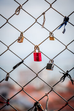 Lovelocks: The romantic tradition of sweethearts locking padlocks to a fence on a bridge, symbolizing their enduring love for each other.