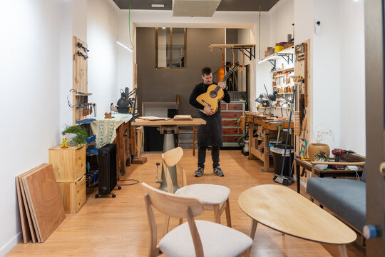 Luthier, Guitar Maker, Working In The Workshop. 