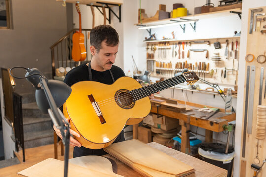 Luthier, Guitar Maker, Working In The Workshop. 