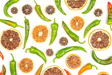 hot green peppers and dried citrus fruit on a white background. grocery organic flatley
