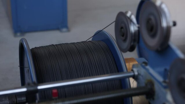 Conveyor-driven, Factory operations, Conveyor solutions. Production plant focuses on creating black-insulated cables through conveyor-based process.