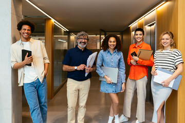 Smiling colleagues standing in workspace