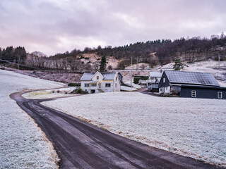Fana village houses after fist winter snowfall in Hordaland, Norway