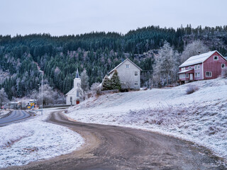 Opheim village houses and church during first winter snowfall in Buskerud, Norway