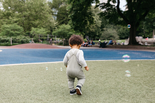 A little toddler boy walking around Central Park in NYC