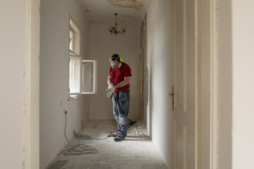 A construction worker in the apartment during a home renovation