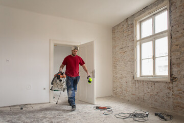 A construction worker in the apartment during a home renovation