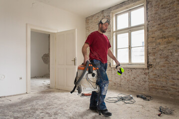 A construction worker in the apartment during a home renovation