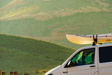 Canoe on roof top of car van