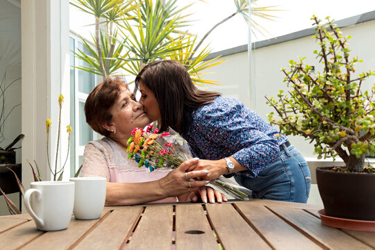 Senior Mother Receives Flowers From Her Daughter