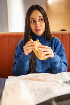 teenage girl having dinner in a restaurant