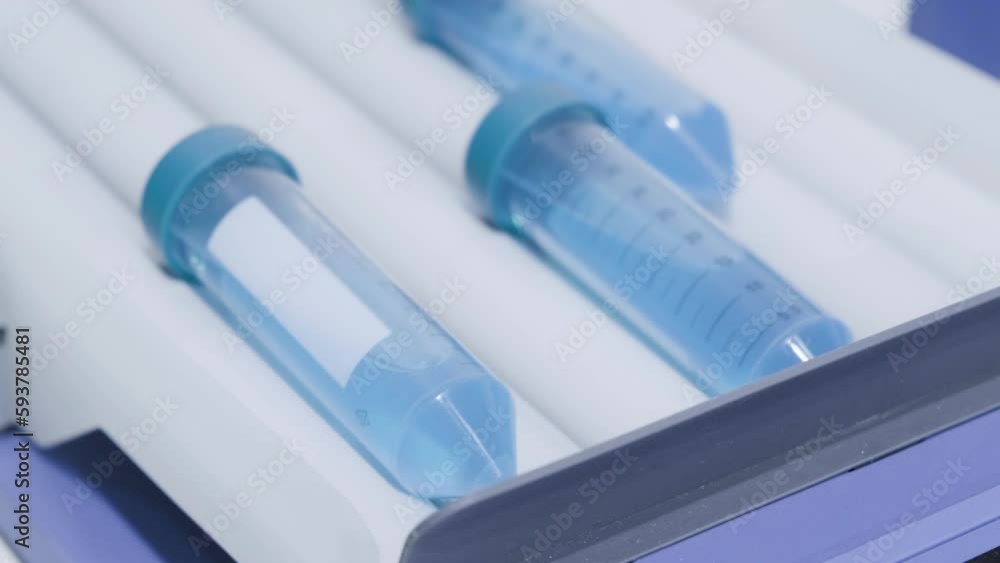 Poster Liquid mixing in glass beaker for science experiment. Close up.  Analytical laboratory.  Mixing of the solution. Laboratory Mixer.