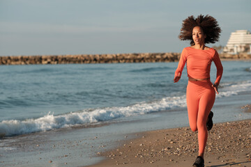 Fototapeta premium Active woman jogging on the beach