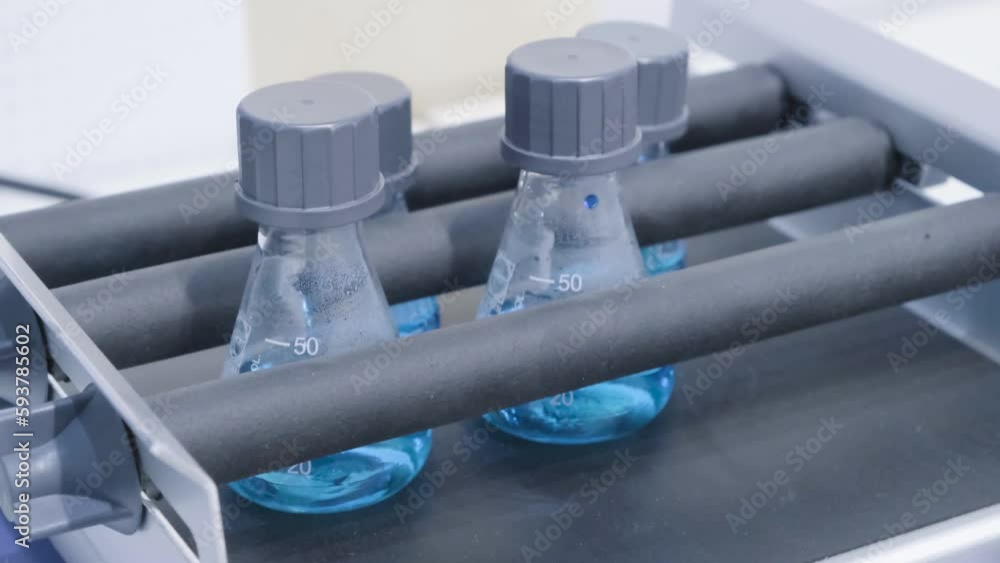 Poster liquid mixing in glass beaker for science experiment. close up. analytical laboratory. mixing of the