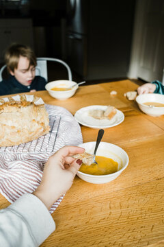ugc pov photo of hand dipping bread into healthy soup