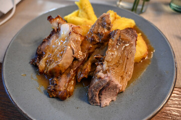 Roast veal and potatoes served on the table in the restaurant.