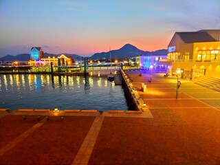 日本の長崎県の観光地、佐世保港のイルミネーションの電飾が美しい夕方の風景（コピースペースあり）