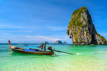 Long tail boats and cliff rock in azure water, Ko Rang Nok, Ao Phra Nang Beach, Ao Nang, Krabi, Thailand