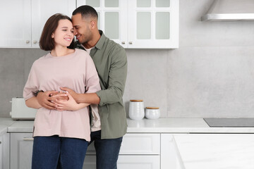 Dating agency. Lovely couple embracing in kitchen, space for text