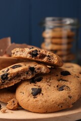 Delicious chocolate chip cookies on wooden tray, closeup